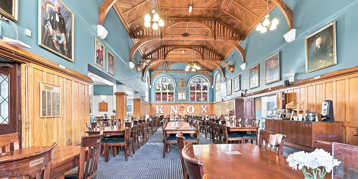 Dining hall with wooden ceiling and paintings on the walls