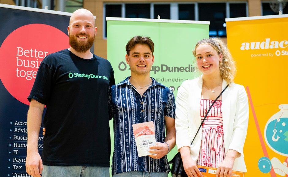 Alex and Abby standing with a representive of Startup Dunedin. 
