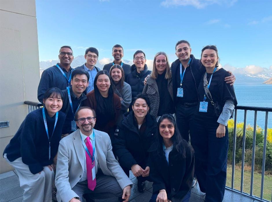 Staff and students are pictured outside on a balcony.