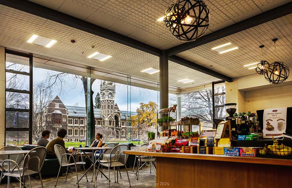 Inside St David Cafe, with people sitting by the window and the University clocktower in the background