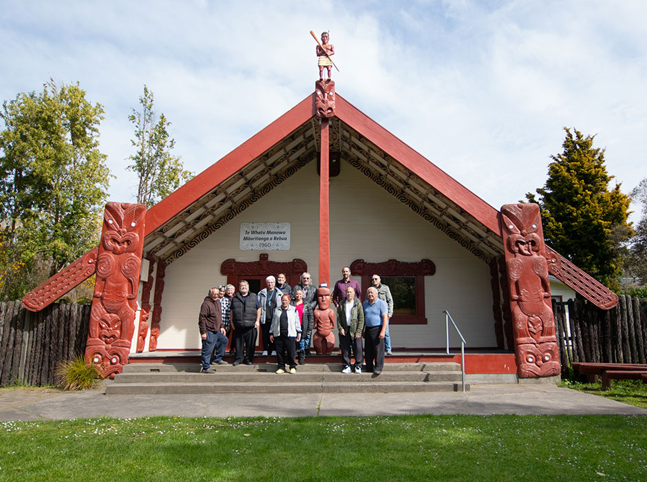 People standing at the front of a Marae