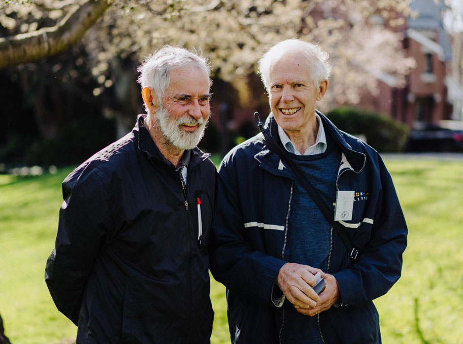 Two men are pictured outside smiling.