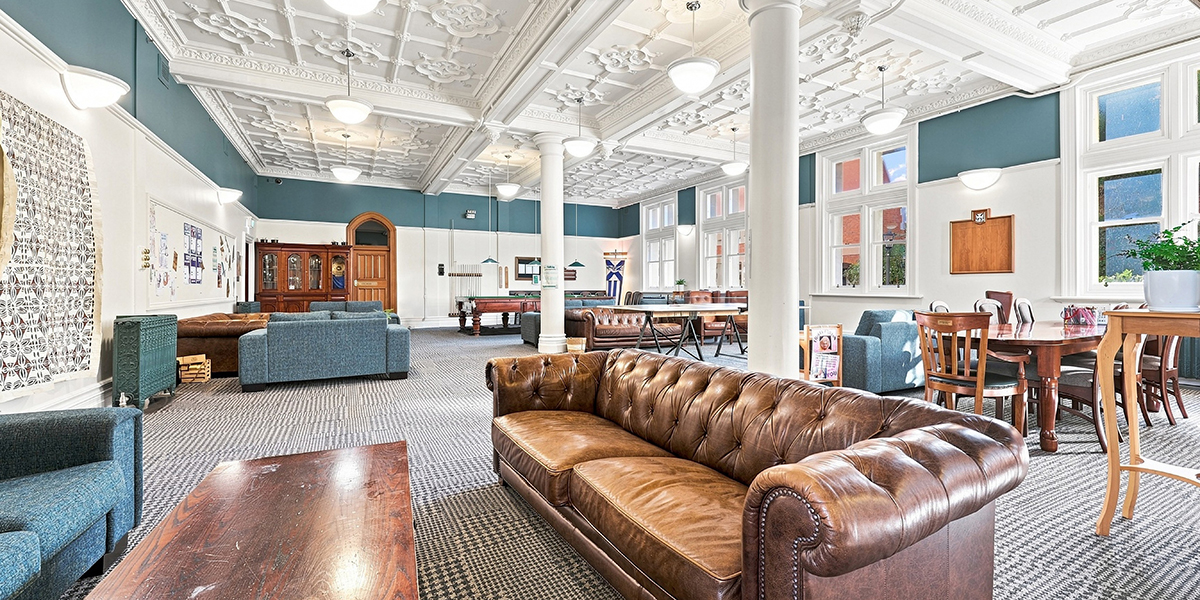 Large common room with couches and a pool table