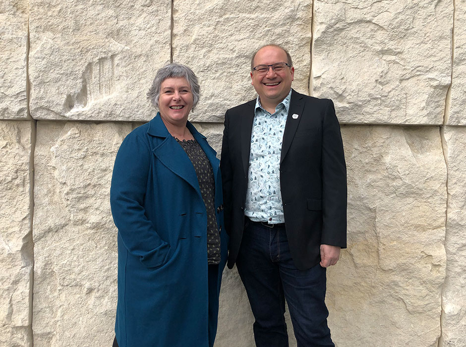 A man and a woman standing next to each other 