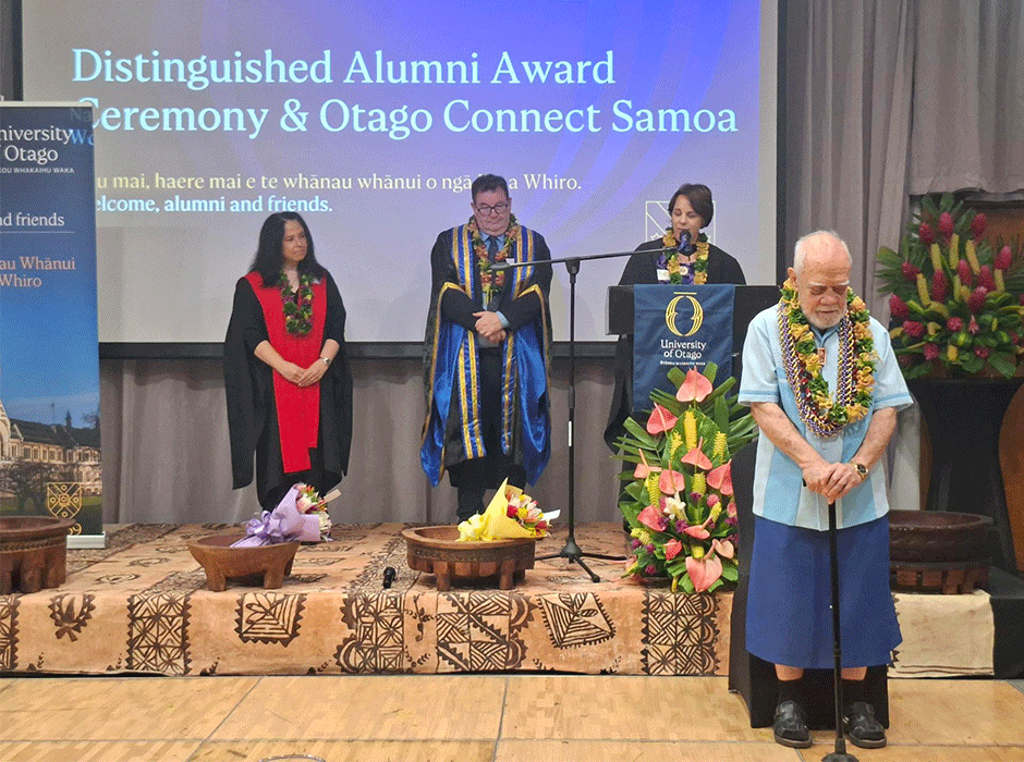 man being presented award by three people