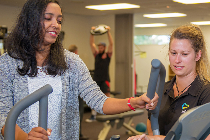 Physiotherapist working with patient in gym