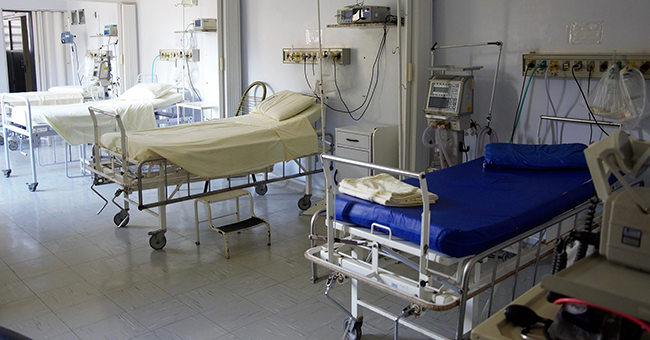 Row of beds in a hospital ward image.