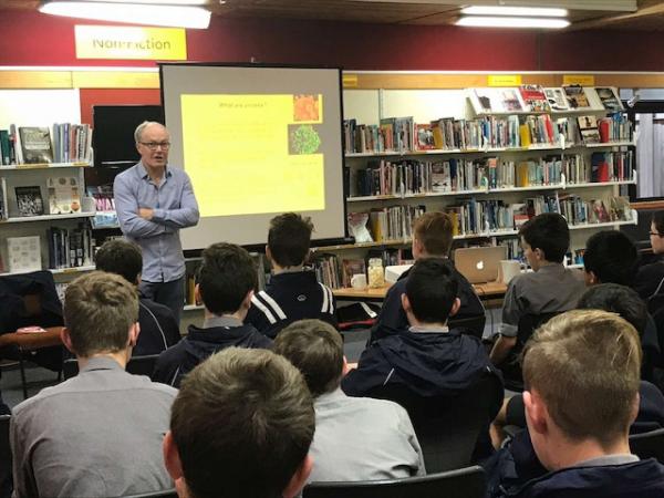 Professor Greg Cook talks to a local high school group about the action of bacteria and viruses, and the growing threat of antimicrobial resistance