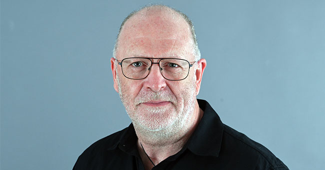 A headshot of Paul Kane.