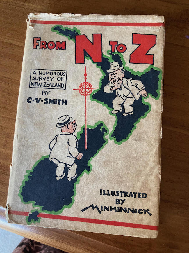 A photo of a tatty-looking book with a cartoon of New Zealand on its cover.