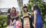 Pacific graduate with family in front of the clocktower 186