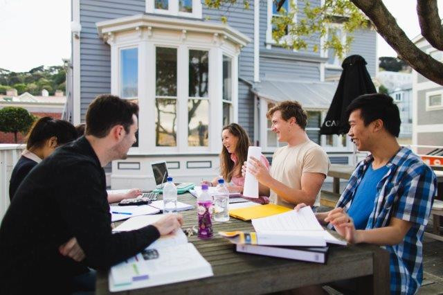 5 students studying in outdoor dining area large photo