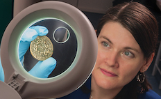 Gwynaeth McIntyre examining Roman coin