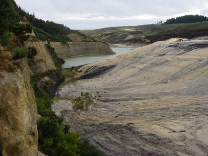 Lake at Wangaloa, downstream of recently-contoured waste rock, with pyrite-bearing coal