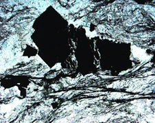 Micro view of pyrite and arsenopyrite. They appear as black blocks broken apart