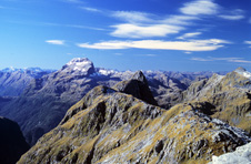 Mt Irene, the prominent peak in the distance, is composed of a metasedimentary upper plate separated from a meta-igneous lower plate by the extensional Mt Irene Shear Zone. Murchison Mountains, Fiordland.