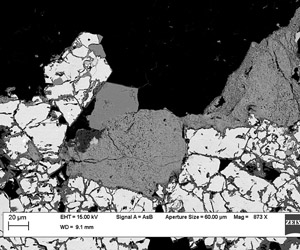 Clusters of hydrothermal zircons nucleate in microveins and along the edges of arsenopyrite.
