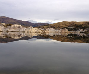 Reflection of west dipping sediments. Blue Lake, St Bathans, Central Otago