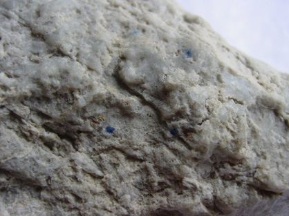 Close-up view of another fragment of quartz vein from a fault zone near Earnscleugh with several visible gold particles near the blue dots. The largest gold particle is 1 mm across.