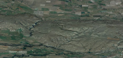 Oblique view of the Raggedy Range from the northwest, with Manuherikia River in foreground and Poolburn valley in background 250px