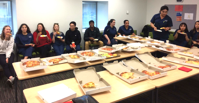 Dentistry students enjoy a pizza lunch