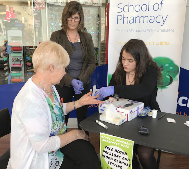 Pharmacy student doing a blood glucose test with a member of the public image 650