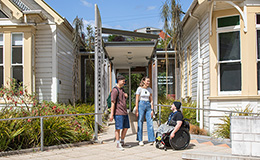 Three students outside the entrance to the Māori Centre image