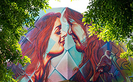 Fluke mural on building of two people doing Māori hongi greeting image