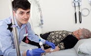 Medical student inserting an IV drip