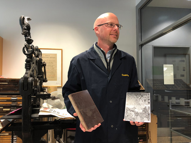 Chris Smith holding copper printing plates