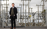 Peter Gibbard standing outside with power poles in the background thumbnail