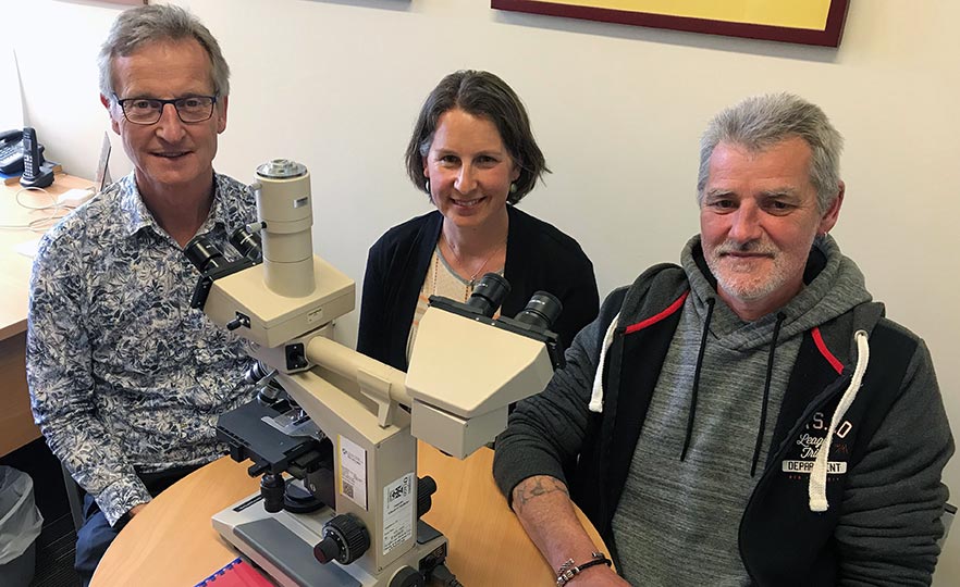 Professor Ian Morison, Jackie Ludgate and Ray McCormick with microscope image