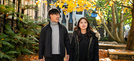 Internation students walking through courtyard in autumn thumbnail