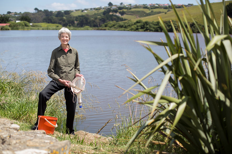 Carolyn Burns standing outside next to a body of water