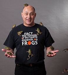 Phil Bishop standing with frogs jumping around him