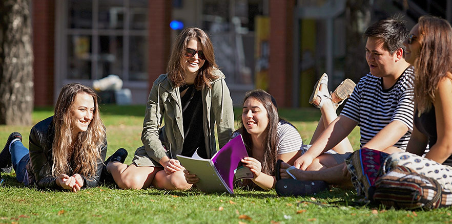 Students sitting on the grass talking