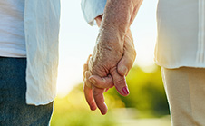 Elderly couple holding Hands image