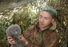 Sp Corey Bragg examines a sotty shearwater chick. Corey's research was about sustainable harvest and predator protection for sooty shearwaters (muttonbirds)