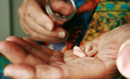 Elderley hand holding a handful of pills_thumbnail