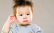 Young child with hand on ear thumbnail