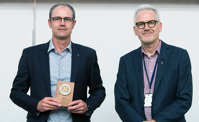 Professor Tim Woodfield with his research gold medal and campus Dean, Professor David Murdoch image