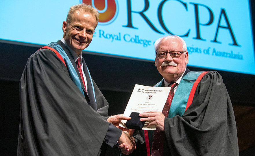 Richard Scolyer (left) presenting RCPA Article of the Year award 2022 to Brett Delahunt  (right) image