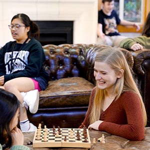 Students playing chess inside St Margaret's College