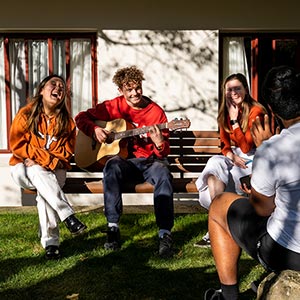 UniCol students playing guitar outside