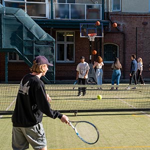 Cumberland students playing tennis outside