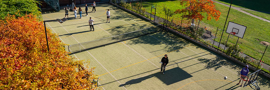 Cumberland students playing basketball outside on court