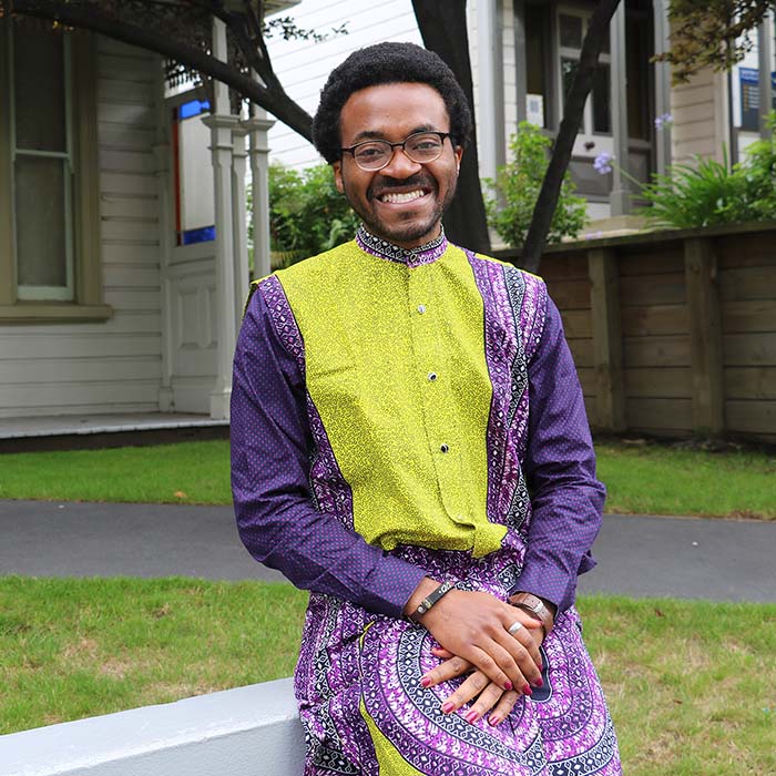 International student in traditional clothing on campus