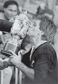 All Black captain, David Kirk, kisses the William Webb Ellis trophy at Eden Park, Auckland, 22 June 1987. Photographer: The Evening Post , chromogenic (colour) photograph, 2004,  chromogenic (colour) photograph, 2004, Dominion Post Collection,  Photographic Archive, Ref: EP/1987/2998/22,  Alexander Turnbull Library
